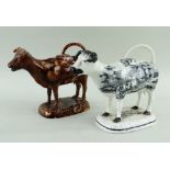 TWO SWANSEA COW CREAMERS comprising (1) brown glazed version and Baker Bevans & Irwin black transfer
