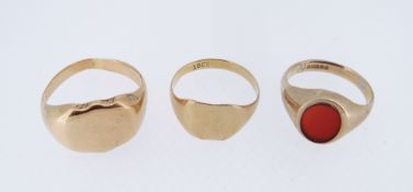 THREE YELLOW METAL RINGS comprising an 18ct gold signet ring, 9ct gold carnelian ring and a yellow