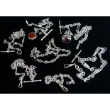 SEVEN SILVER WATCH CHAINS of various design one with revolving bloodstone and carnelian fob, another