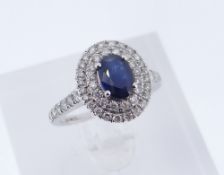 18CT WHITE GOLD SAPPHIRE & DIAMOND HALO RING, the central sapphire measuring 7 x 5mms approx.,