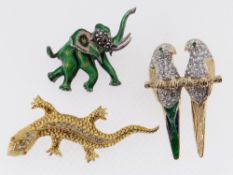 THREE ANIMAL DESIGN BAR BROOCHES to include enamel elephant, stone set lizard and pair of parrots (
