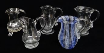 FIVE VARIOUS GLASS CREAM JUGS, including three early 19th Century jug, one with rib moulded baluster