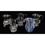 FIVE VARIOUS GLASS CREAM JUGS, including three early 19th Century jug, one with rib moulded baluster