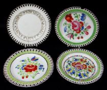 FOUR SWANSEA POTTERY RIBBON PLATES each with typical basket-weave borders, three painted with