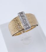 18CT YELLOW & WHITE GOLD FIVE-STONE DIAMOND RING, having textured shank, stamped 'K18', ring size O,