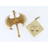 TWO 18CT YELLOW GOLD PENDANTS, one a double sided axe and the other depicting weighing scales,
