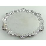 LATE VICTORIAN SILVER SALVER, shell and scroll border, raised on three scroll feet, Birmingham 1897,