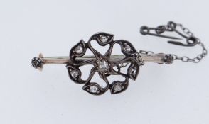 WHITE METAL FLOWER HEAD BAR BROOCH, set with rose cut diamonds, 3.7gms Provenance: private