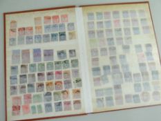 STAMPS: Slim brown stock book partially filled, containing interesting used collection of Queen