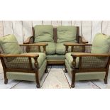 OAK & BERGERE CANE THREE PIECE LOUNGE SUITE having swept arms overturned and block front supports,