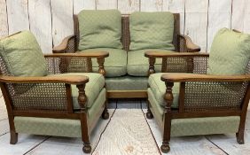 OAK & BERGERE CANE THREE PIECE LOUNGE SUITE having swept arms overturned and block front supports,