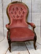 VICTORIAN WALNUT SPOONBACK SALON ARMCHAIR in button pink upholstery having carved detail to the