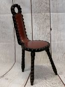 CARVED OAK WELSH SPINNER'S CHAIR, three legged with red leather effect buttoned seat and back, 83cms
