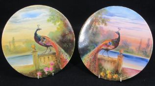 WILLIAM BIRBECK HAND PAINTED PORCELAIN PLAQUES (2) depicting opposing peacocks with variant