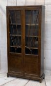 VINTAGE OAK TWO DOOR BOOKCASE with sunburst effect beading to the glass, with interior adjustable