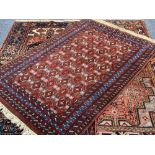 EASTERN STYLE WOOLLEN CARPETS (3), all red ground with classical style central patterns and multi-