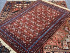 EASTERN STYLE WOOLLEN CARPETS (3), all red ground with classical style central patterns and multi-
