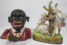CAST IRON MECHANICAL MONEY BANK and a continental porcelain group of a courting couple, 13 and