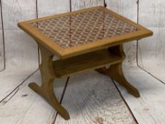 STYLISH OAK COFFEE TABLE with under tier shelf, having a glass topped needlework insert, 46cms H,