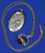 NINE CARAT GOLD OVAL LOCKET and a spinning open work fob, set with three hard stones, on a fine link