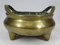 CHINESE POLISHED BRONZE CENSER - having twin loop handles to a globular body on three conical