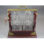 TANTALUS, reproduction, two bottle with a pair of hobnail cut, square based decanters, locking key