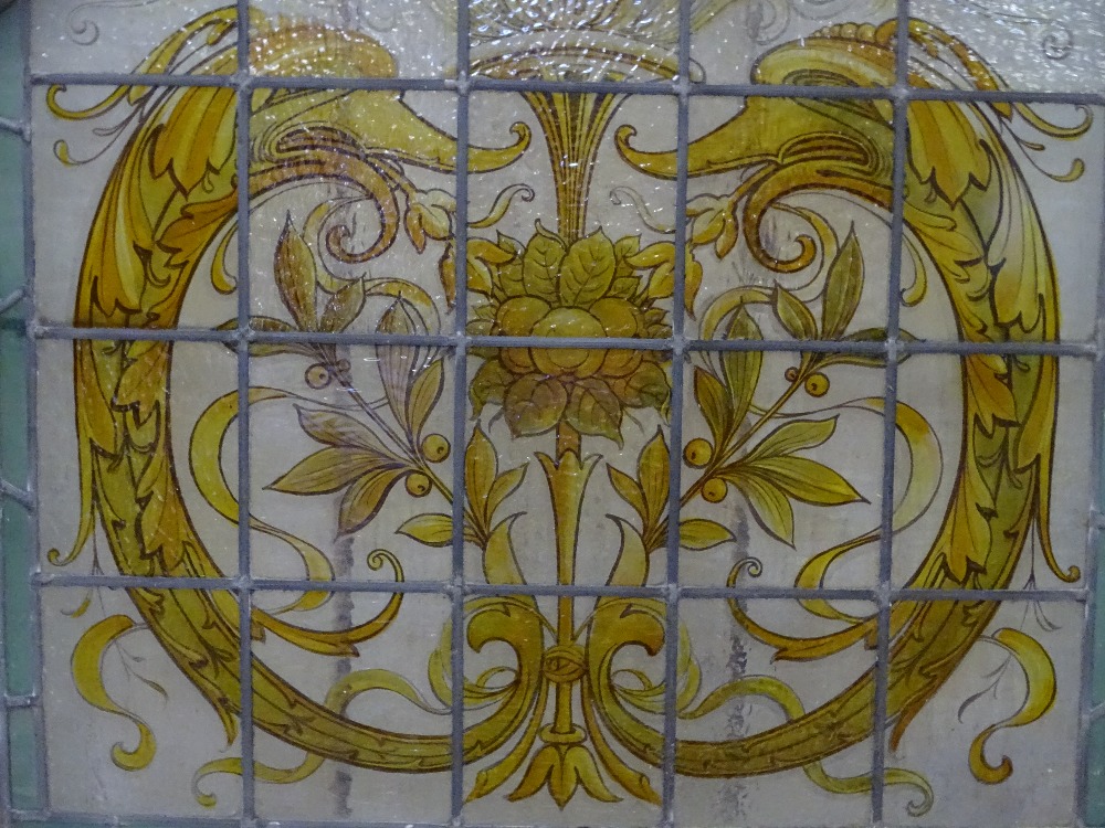 STAINED & PAINTED LEADED GLASS WINDOW PANEL - in slightly curved frame, 78 x 85cms overall