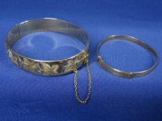 NINE CARAT GOLD BANGLES (2) including a child's example with wavy type pattern, 3.9 grms and a