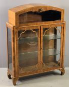 ART DECO STYLE DISPLAY CABINET with domed top, drop down upper section over two glazed doors, 119cms
