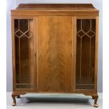 CIRCA 1920 MAHOGANY RAILBACK CHINA CABINET with two glazed doors either side of a central door, on