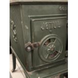JOTUL GREEN ENAMELLED CAST IRON STOVE with possibly associated flue attachments, 64cms H, 33cms W,