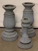 CAST IRON PLANTER STANDS, a pair plus one other, the pair having upturned acanthus leaf and egg