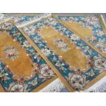 CHINESE WASHED WOOLEN RUGS (3) - orange ground with wide floral border against a blue background