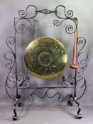 BRASS GONG in a floorstanding wrought iron stand, 85cms H