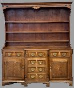 LATE 19th CENTURY CROSSBANDED OAK NORTH WALES DRESSER with breakfront, three shelf rack and a T-