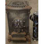 VINTAGE CAST IRON GAS STOVE with possibly associated flue attachments, 84cms H, 48cms W, 55cms D