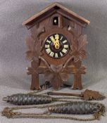 BLACK FOREST TYPE CUCKOO CLOCK with twin pine cone weights, 23 x 16cms