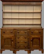 CIRCA 1860 ANGLESEY OAK DRESSER with breakfront, painted rack and three drawers over two cupboard