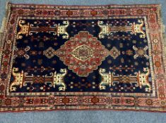 PERSIAN HAND WOVEN RUG - blue and red ground with central medallion and twin horses on columns