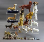 ORNAMENTAL DOG FIGURINES - a mixed quantity in pottery, porcelain and composition along with a