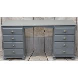 REPRODUCTION PAINTED PINE DRESSING TABLE - having twin banks of four drawers with brass and