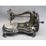 VINTAGE JONES COMPANY HAND CRANK SEWING MACHINE with applied decorative plaques and stamps as