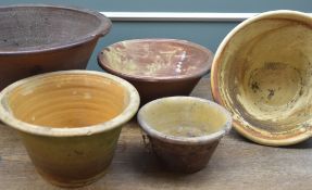 GROUP OF FIVE SLIP GLAZED POTTERY DAIRY PANS, largest 43cms diam.