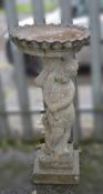 RECONSTITUTED STONE FIGURAL BIRD TABLE, 83cms high