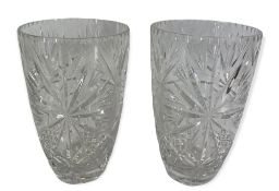 GLASSWARE - a near pair of heavy cut glass vases, 25cms tall