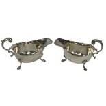 SILVER SAUCE BOATS, A PAIR - Birmingham 1939 and 1940 having 'C' scroll handles on three hoof