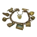 9CT GOLD CHARM BRACELET - with padlock clasp and 10 charms, all stamped 9ct, 41grms gross