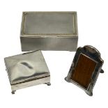 SILVER CIGARETTE BOXES (2) and a small easel back photograph frame, London 1927 the larger box,