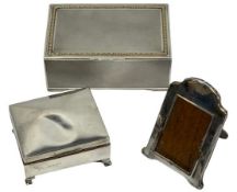 SILVER CIGARETTE BOXES (2) and a small easel back photograph frame, London 1927 the larger box,