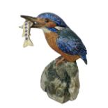 NEIL DALRYMPLE CERAMIC SCULPTURE OF A KINGFISHER WITH CATCH - standing on a rocky mount, incised